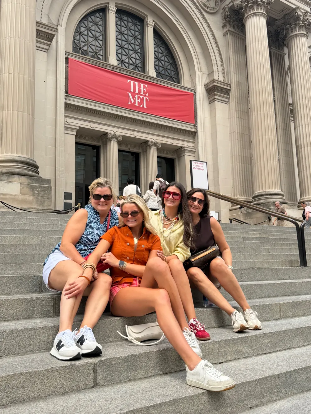Visitors sitting on the Met steps on Fifth Avenue, a Gossip Girl filming location in Manhattan